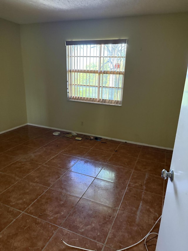 4145 Cypress Reach Ct Unit 503, Pompano Beach, FL 33069 - empty room with dark tile patterned floors and baseboards