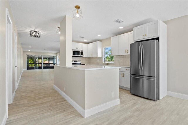 13921 Royal Palm Ct Unit D, Delray Beach, FL 33484 - kitchen with stainless steel appliances, a sink, light countertops, light wood-style floors, and recessed lighting
