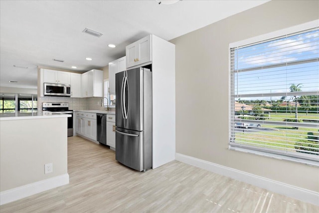13921 Royal Palm Ct Unit D, Delray Beach, FL 33484 - kitchen with stainless steel appliances, baseboards, a sink, light countertops, and recessed lighting