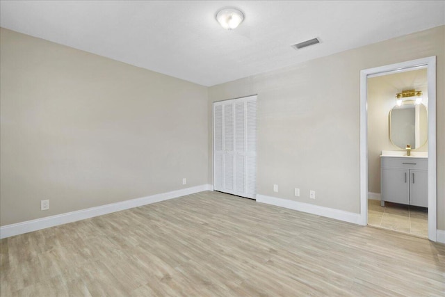 13921 Royal Palm Ct Unit D, Delray Beach, FL 33484 - unfurnished bedroom featuring light wood-style floors, baseboards, a closet, and ensuite bathroom