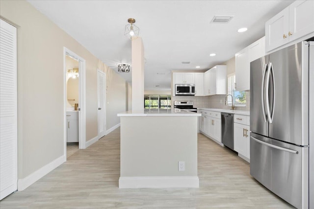 13921 Royal Palm Ct Unit D, Delray Beach, FL 33484 - kitchen with appliances with stainless steel finishes, light countertops, white cabinets, plenty of natural light, and recessed lighting