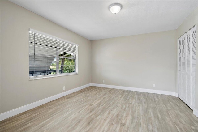 13921 Royal Palm Ct Unit D, Delray Beach, FL 33484 - unfurnished bedroom featuring wood finished floors, baseboards, and a closet