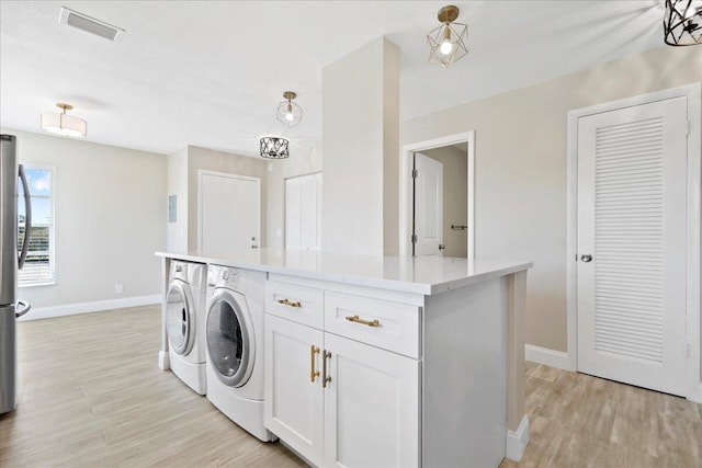 13921 Royal Palm Ct Unit D, Delray Beach, FL 33484 - laundry room with washing machine and clothes dryer, baseboards, and light wood-style flooring