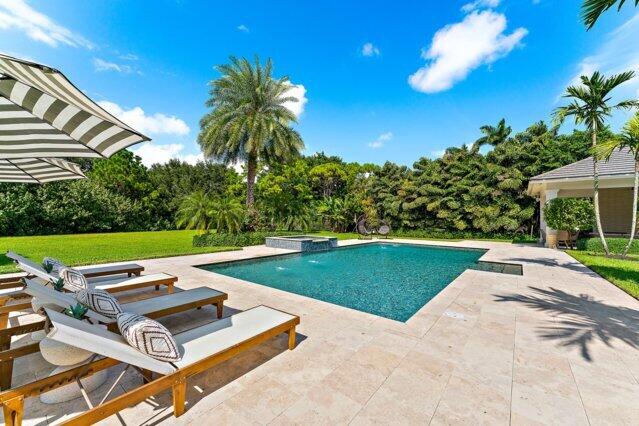 7703 Bold Lad Rd, Palm Beach Gardens, FL 33418 - view of swimming pool featuring a patio and a pool with connected hot tub