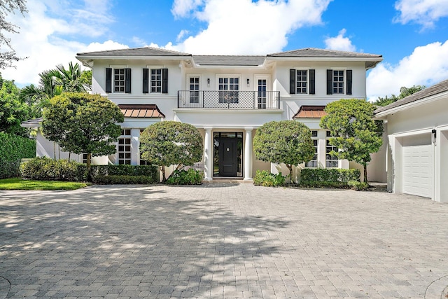 7703 Bold Lad Rd, Palm Beach Gardens, FL 33418 - view of front facade featuring a balcony, decorative driveway, and stucco siding