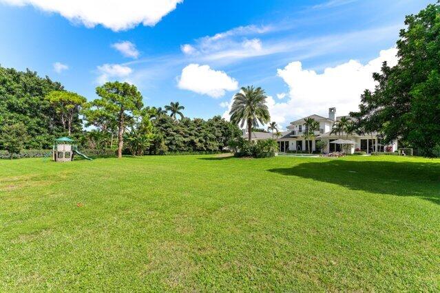 7703 Bold Lad Rd, Palm Beach Gardens, FL 33418 - view of green lawn with a playground