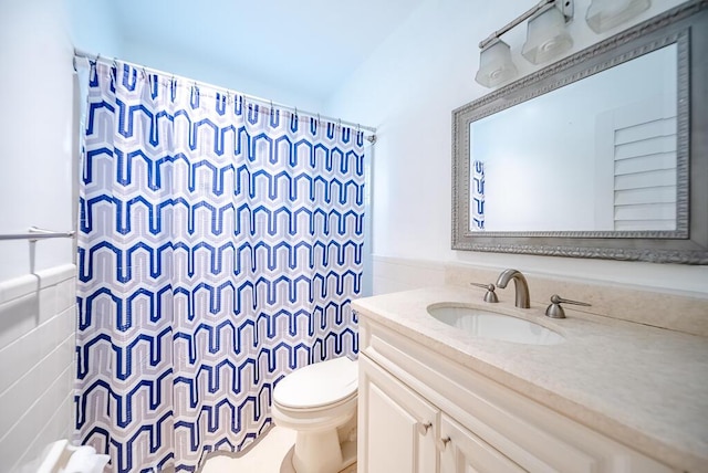 1950 N Conference Dr, Boca Raton, FL 33486 - bathroom with tile walls, toilet, vanity, a shower with curtain, and wainscoting