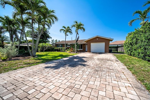 1950 N Conference Dr, Boca Raton, FL 33486 - ranch-style house featuring decorative driveway, a garage, and stucco siding