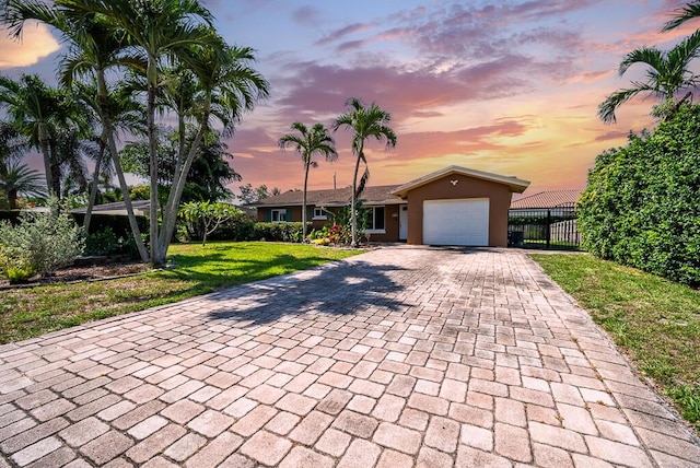 1950 N Conference Dr, Boca Raton, FL 33486 - view of front of house featuring decorative driveway, a garage, and stucco siding
