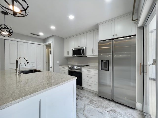 6503 Geminata Oak Ct, Palm Beach Gardens, FL 33410 - kitchen featuring appliances with stainless steel finishes, a sink, light marble finish floors, white cabinetry, and recessed lighting