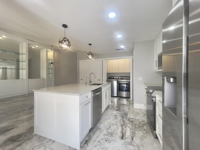 6503 Geminata Oak Ct, Palm Beach Gardens, FL 33410 - kitchen with stainless steel appliances, washing machine and dryer, an island with sink, recessed lighting, and light marble finish flooring
