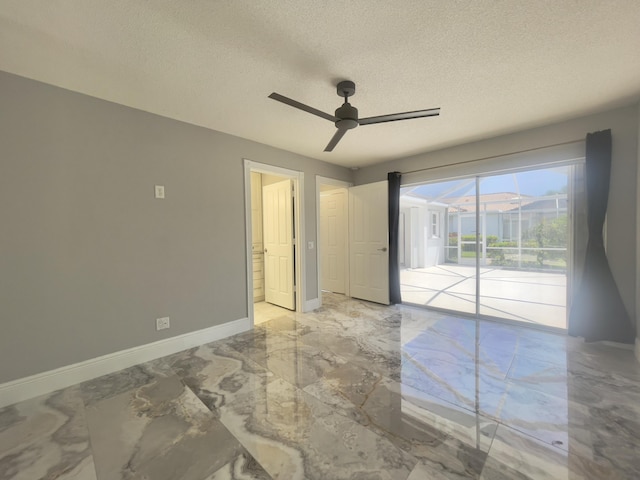 6503 Geminata Oak Ct, Palm Beach Gardens, FL 33410 - spare room with marble tiled flooring, a textured ceiling, a ceiling fan, and baseboards