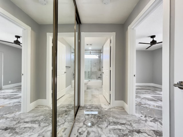 6503 Geminata Oak Ct, Palm Beach Gardens, FL 33410 - corridor with marble tiled floors and baseboards