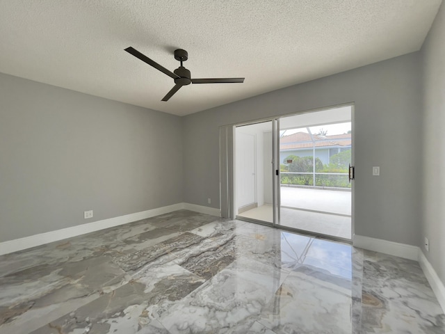 6503 Geminata Oak Ct, Palm Beach Gardens, FL 33410 - spare room with marble tiled floors, a textured ceiling, baseboards, and a ceiling fan