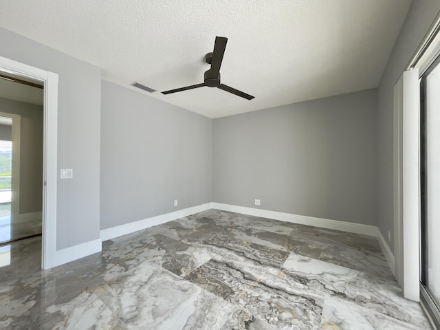 6503 Geminata Oak Ct, Palm Beach Gardens, FL 33410 - unfurnished room with a ceiling fan, marble tiled flooring, a textured ceiling, and baseboards
