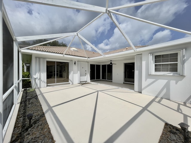 6503 Geminata Oak Ct, Palm Beach Gardens, FL 33410 - back of property featuring a patio, ceiling fan, a tiled roof, a lanai, and stucco siding
