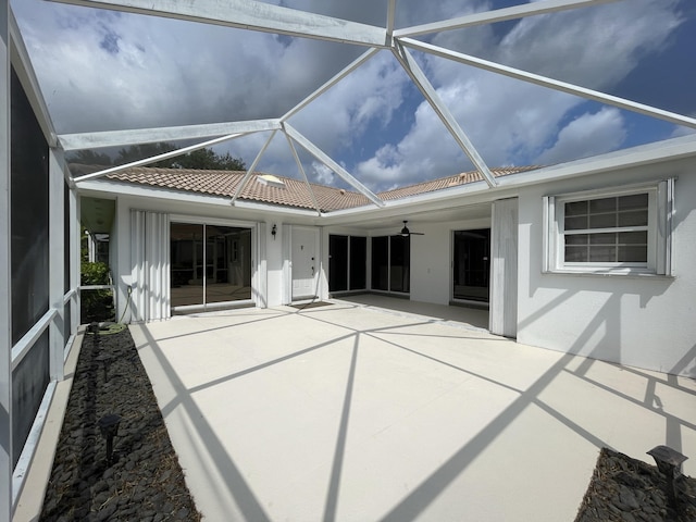 6503 Geminata Oak Ct, Palm Beach Gardens, FL 33410 - back of property with a patio area, ceiling fan, stucco siding, glass enclosure, and a tiled roof