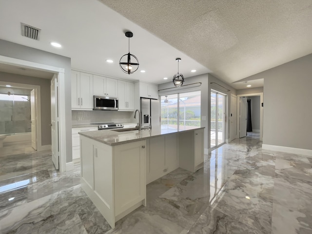 6503 Geminata Oak Ct, Palm Beach Gardens, FL 33410 - kitchen featuring stainless steel appliances, light marble finish floors, recessed lighting, white cabinetry, and an island with sink