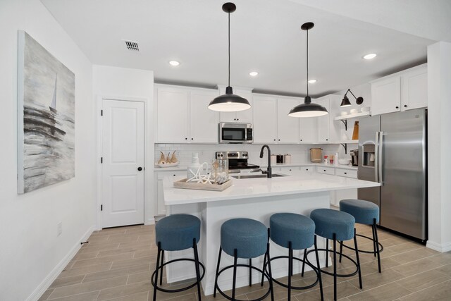 201 Ocarina St SW Unit 78, Palm Bay, FL 32908 - kitchen with appliances with stainless steel finishes, wood tiled floors, baseboards, and recessed lighting