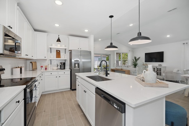 201 Ocarina St SW Unit 78, Palm Bay, FL 32908 - kitchen featuring stainless steel appliances, a sink, tasteful backsplash, open floor plan, and lofted ceiling