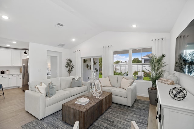 201 Ocarina St SW Unit 78, Palm Bay, FL 32908 - living room featuring vaulted ceiling, wood finish floors, and recessed lighting
