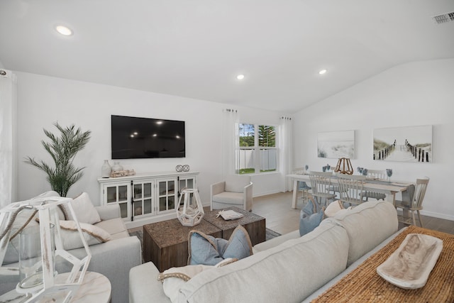 201 Ocarina St SW Unit 78, Palm Bay, FL 32908 - living area featuring vaulted ceiling, baseboards, and recessed lighting