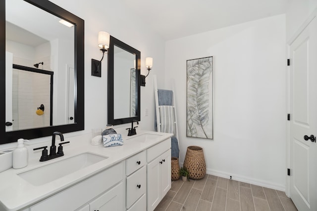 201 Ocarina St SW Unit 78, Palm Bay, FL 32908 - bathroom featuring double vanity, tiled shower, baseboards, and wood finish floors