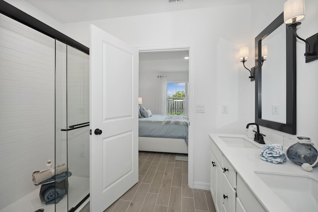 201 Ocarina St SW Unit 78, Palm Bay, FL 32908 - ensuite bathroom with a shower stall, double vanity, wood finished floors, and baseboards