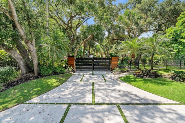 5488 Pennock Point Rd, Jupiter, FL 33458 - view of patio with a gate and view of scattered trees