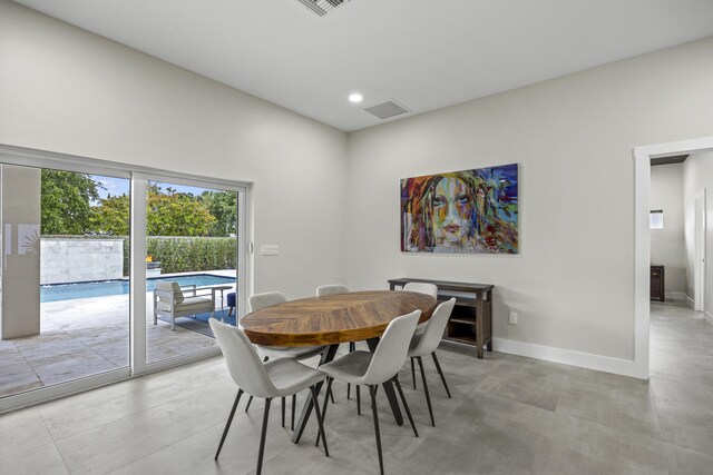 7802 Martin Ave, West Palm Beach, FL 33405 - kitchen featuring wall chimney range hood, dark cabinets, stainless steel appliances, light stone counters, and recessed lighting