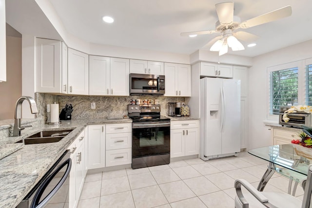 5746 Crystal Shores Dr Unit 206, Boynton Beach, FL 33437 - kitchen featuring appliances with stainless steel finishes, a sink, backsplash, light stone counters, and white cabinets