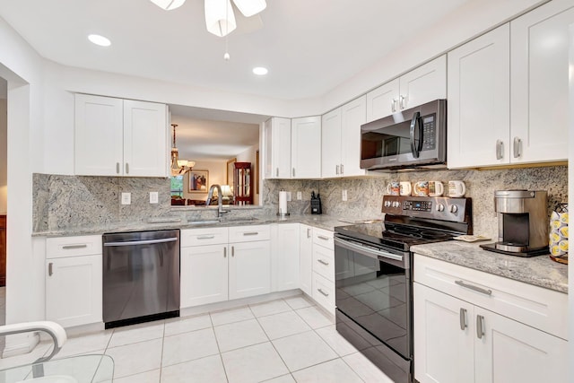 5746 Crystal Shores Dr Unit 206, Boynton Beach, FL 33437 - kitchen featuring stainless steel appliances, a sink, white cabinetry, light stone counters, and recessed lighting