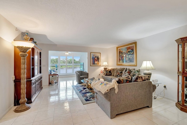 5746 Crystal Shores Dr Unit 206, Boynton Beach, FL 33437 - living room featuring light tile patterned flooring, a ceiling fan, a textured ceiling, and baseboards
