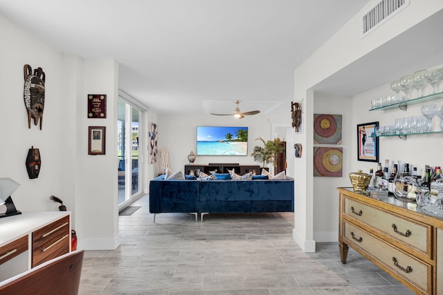 6699 NW 2nd Ave Unit 109, Boca Raton, FL 33487 - living room with a ceiling fan, light wood-style floors, baseboards, and a bar