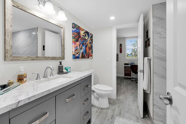 6699 NW 2nd Ave Unit 109, Boca Raton, FL 33487 - bathroom featuring vanity, wood finished floors, toilet, recessed lighting, and baseboards