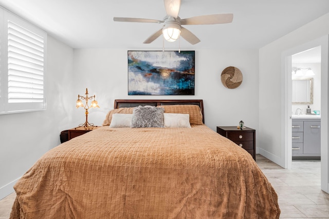 6699 NW 2nd Ave Unit 109, Boca Raton, FL 33487 - bedroom featuring light wood finished floors, ensuite bathroom, a sink, and baseboards