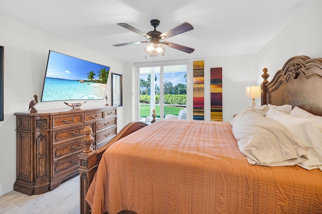 6699 NW 2nd Ave Unit 109, Boca Raton, FL 33487 - bedroom with access to outside, light wood-style flooring, and a ceiling fan