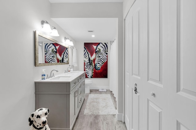 6699 NW 2nd Ave Unit 109, Boca Raton, FL 33487 - full bath with double vanity, toilet, wood finished floors, a shower with curtain, and baseboards