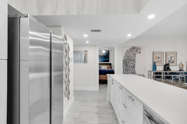 6699 NW 2nd Ave Unit 109, Boca Raton, FL 33487 - kitchen featuring freestanding refrigerator, white cabinetry, baseboards, recessed lighting, and light countertops