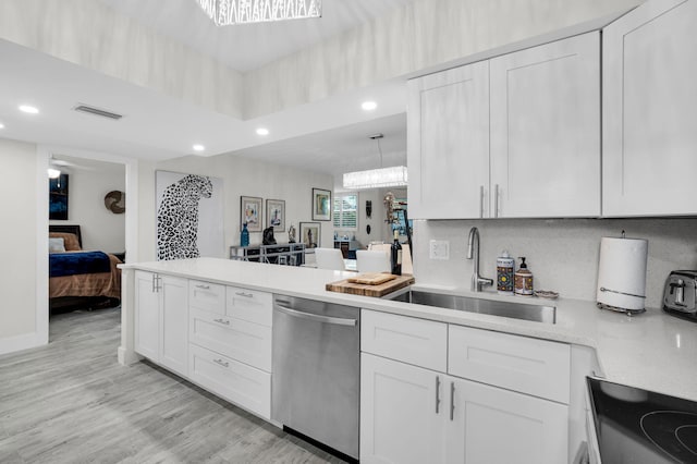 6699 NW 2nd Ave Unit 109, Boca Raton, FL 33487 - kitchen with stainless steel dishwasher, a sink, recessed lighting, a peninsula, and white cabinets