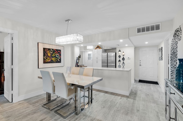 6699 NW 2nd Ave Unit 109, Boca Raton, FL 33487 - dining space with light wood-style floors, baseboards, recessed lighting, and a chandelier