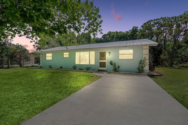 6503 SE Lillian Ct, Stuart, FL 34997 - ranch-style house featuring stucco siding, metal roof, and concrete driveway