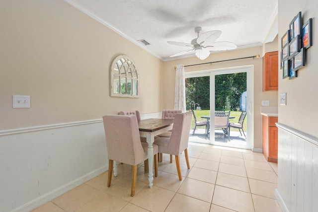 6503 SE Lillian Ct, Stuart, FL 34997 - dining area with crown molding, a textured ceiling, ceiling fan, light tile patterned floors, and baseboards