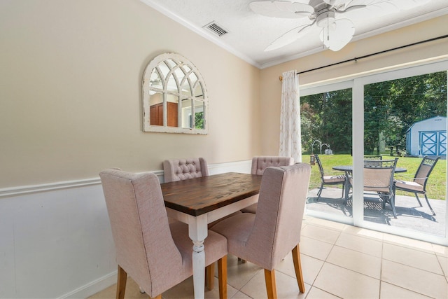 6503 SE Lillian Ct, Stuart, FL 34997 - dining room featuring ornamental molding, light tile patterned floors, ceiling fan, baseboards, and a textured ceiling