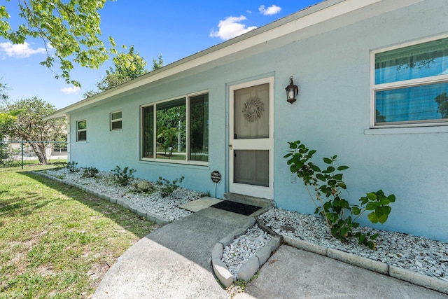 6503 SE Lillian Ct, Stuart, FL 34997 - doorway to property with stucco siding