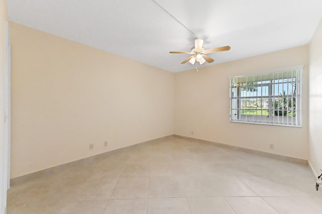 7 Normandy Unit A, Delray Beach, FL 33484 - empty room with ceiling fan, light tile patterned flooring, and baseboards