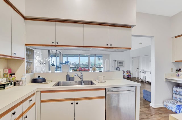 19411 Sabal Lake Dr Unit 5018, Boca Raton, FL 33434 - kitchen featuring dishwasher, a sink, light wood-style flooring, light countertops, and white cabinets