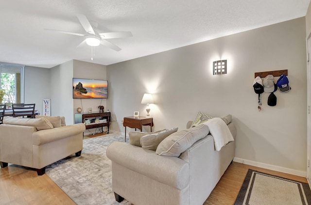 700 Scotia Dr Unit 202, Hypoluxo, FL 33462 - living room featuring light wood-type flooring, baseboards, and ceiling fan