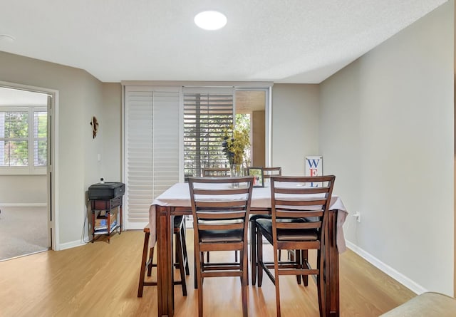 700 Scotia Dr Unit 202, Hypoluxo, FL 33462 - dining area featuring light wood-type flooring and baseboards