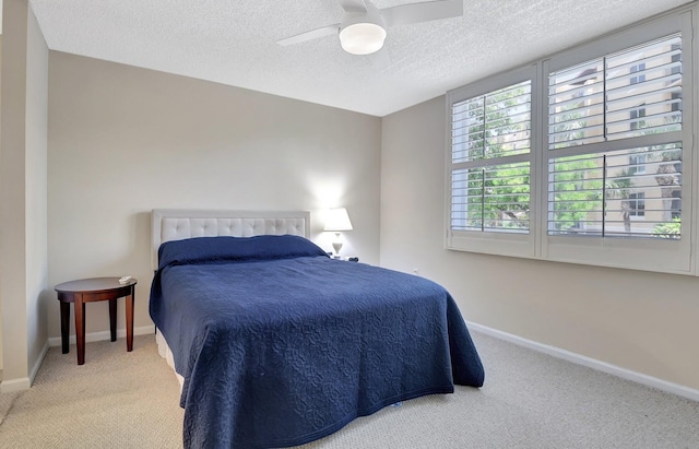 700 Scotia Dr Unit 202, Hypoluxo, FL 33462 - bedroom featuring carpet flooring, baseboards, a textured ceiling, and a ceiling fan